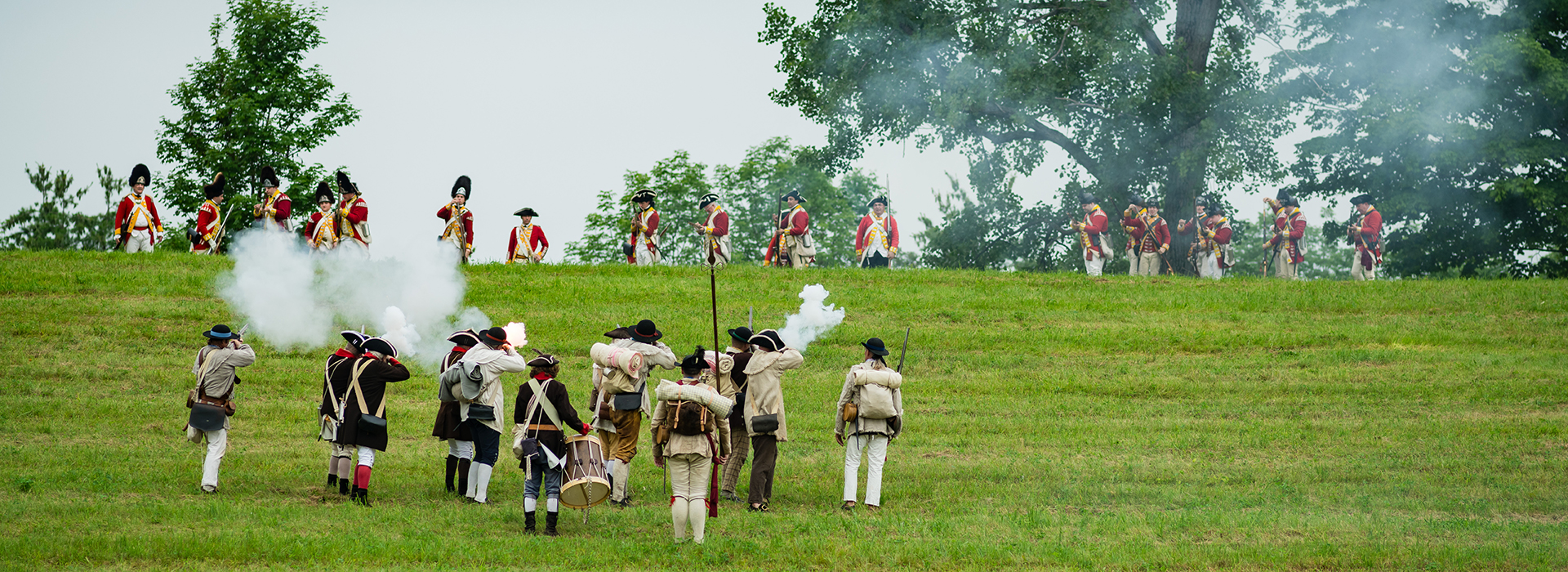 people standing on a grassy hill 